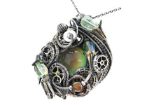 Load image into Gallery viewer, Color-Changing "Mood" Steampunk Pendant in Sterling Silver with UV-Reactive Glass